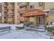 El Posado apartment building entrance with snow-covered walkway and landscaping at 625 N Pennsylvania St # 108, Denver, CO 80203