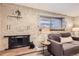 Living room fireplace with brick surround and gray couch at 625 N Pennsylvania St # 108, Denver, CO 80203
