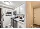 White kitchen with stainless steel appliances and sink at 625 N Pennsylvania St # 108, Denver, CO 80203