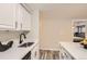 Modern kitchen with white cabinets and stainless steel appliances at 625 N Pennsylvania St # 108, Denver, CO 80203