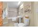The bathroom features a shower, a sink, a toilet, and brick accents, adding character to the space at 2500 Walnut St # 102, Denver, CO 80205