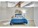 Cozy bedroom boasts a bright blue bed, industrial details, and a stylish accent wall for a modern touch at 2500 Walnut St # 102, Denver, CO 80205