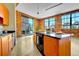 Bright, open kitchen features brick walls, stainless steel appliances, and a center island with a black countertop at 2500 Walnut St # 102, Denver, CO 80205