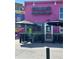 Exterior of Snarf's Sandwiches with a bright pink facade, catering options, and patio seating at 2500 Walnut St # 102, Denver, CO 80205