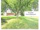 A beautifully landscaped backyard featuring mature trees and ample green space for outdoor activities at 8030 Ogden St, Denver, CO 80229