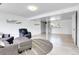 A basement living room featuring a sofa and chair, with a round rug on light-colored flooring at 8030 Ogden St, Denver, CO 80229