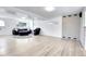 Spacious basement area with light-colored flooring, a gray brick wall, and a comfortable seating arrangement at 8030 Ogden St, Denver, CO 80229