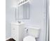 Bathroom featuring white vanity, toilet, large mirror, modern lighting and shower with tile surround at 8030 Ogden St, Denver, CO 80229