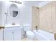 Clean white bathroom featuring a shower and tub combination, bright vanity, and modern toilet at 8030 Ogden St, Denver, CO 80229