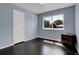 Bedroom with hardwood floors, big window offering natural light, and closet at 8030 Ogden St, Denver, CO 80229