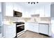 Modern updated kitchen with stainless steel appliances, ample countertops, and tile backsplash at 8030 Ogden St, Denver, CO 80229