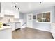 Updated kitchen features modern appliances, ample counter space and stylish tiled floors at 8030 Ogden St, Denver, CO 80229