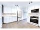 Modern kitchen featuring stainless steel appliances, updated cabinetry, and stylish track lighting at 8030 Ogden St, Denver, CO 80229