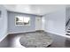Bright living room featuring hardwood floors, large window, and a round decorative rug at 8030 Ogden St, Denver, CO 80229