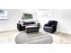Bright living room featuring neutral decor, a round rug, and ample natural light from a large window at 8030 Ogden St, Denver, CO 80229