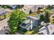 Home with a well-maintained yard, complemented by mature trees and a newly installed solar panel system on adjacent structure at 4501 Zenobia St, Denver, CO 80212