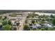 Neighborhood featuring homes nestled among mature trees, with a lake and commercial area in the background, showcasing a blend of living at 4501 Zenobia St, Denver, CO 80212