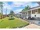 Landscaped backyard features artificial grass, patio with outdoor seating, and a detached garage at 4501 Zenobia St, Denver, CO 80212