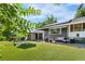 Serene backyard with covered patio, artificial turf, outdoor seating, and detached garage at 4501 Zenobia St, Denver, CO 80212