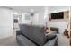 Basement living room includes a sofa, guitars, sliding barn door and flatscreen TV at 4501 Zenobia St, Denver, CO 80212