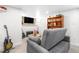 Finished basement features guitars, a flatscreen TV and a wooden bookcase at 4501 Zenobia St, Denver, CO 80212