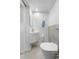 Modern half bathroom features sleek toilet and sink with gray tiled accent wall at 4501 Zenobia St, Denver, CO 80212