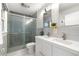 Bright bathroom featuring a modern vanity with double sinks and a sleek glass-enclosed shower at 4501 Zenobia St, Denver, CO 80212