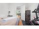 Bright bedroom with a Peloton exercise bike and doorway leading to another room at 4501 Zenobia St, Denver, CO 80212
