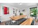 Bright dining area with contemporary table and bench seating adjacent to kitchen at 4501 Zenobia St, Denver, CO 80212