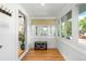 Bright entryway featuring hardwood floors, windows, and seating area with storage racks for shoes at 4501 Zenobia St, Denver, CO 80212