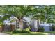 Quaint home featuring a large tree, a well-kept lawn, and a welcoming entrance, ideal for comfortable living at 4501 Zenobia St, Denver, CO 80212