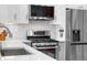 Close up of kitchen with stainless appliances and modern countertop space at 4501 Zenobia St, Denver, CO 80212