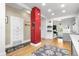 Open kitchen layout with hardwood floors and a red brick accent column at 4501 Zenobia St, Denver, CO 80212