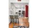 Open concept kitchen featuring white cabinetry, stainless steel appliances, and countertop seating at 4501 Zenobia St, Denver, CO 80212