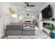 Comfortable living room with a gray sectional couch, modern lighting, and electric fireplace at 4501 Zenobia St, Denver, CO 80212