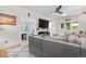 Well-lit living room with an electric fireplace, stylish decor and cozy sectional couch at 4501 Zenobia St, Denver, CO 80212