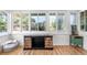 Bright sun room with hardwood floors, multiple windows and a decorative storage cabinet at 4501 Zenobia St, Denver, CO 80212