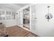 Bright sun room featuring hardwood floors, white trim and view into the living room at 4501 Zenobia St, Denver, CO 80212