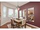 A dining room with natural lighting from the large windows and a wooden table for Gathering meals at 22342 E Plymouth Cir, Aurora, CO 80016