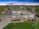 Charming two-story home featuring a well-manicured lawn, stone accents, and an attached two-car garage at 22342 E Plymouth Cir, Aurora, CO 80016