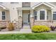 Inviting entryway with stone accents, a secure front door, and vibrant, manicured landscaping at 22342 E Plymouth Cir, Aurora, CO 80016