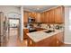 Modern kitchen featuring granite countertops, stainless steel appliances, and warm wood cabinetry at 22342 E Plymouth Cir, Aurora, CO 80016