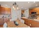 A bright kitchen with updated cabinets, countertops and appliances along with dining room with modern light fixture at 22342 E Plymouth Cir, Aurora, CO 80016