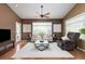 Bright living room featuring hardwood floors, neutral furniture, a ceiling fan, and a cozy atmosphere at 22342 E Plymouth Cir, Aurora, CO 80016
