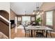Open-concept living and dining area with hardwood floors, contemporary furniture, and stylish lighting at 22342 E Plymouth Cir, Aurora, CO 80016