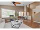 Spacious living area with hardwood floors, a ceiling fan, and an adjacent dining area at 22342 E Plymouth Cir, Aurora, CO 80016