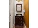 Stylish powder room featuring a dark vanity with a granite countertop and modern lighting at 22342 E Plymouth Cir, Aurora, CO 80016