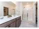 Bright Primary bathroom with dual vanities and walk-in shower with glass enclosure at 2149 Indian Balsam Dr, Monument, CO 80132