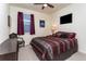 Comfortable bedroom featuring a ceiling fan, mounted television, and neutral carpeting at 2149 Indian Balsam Dr, Monument, CO 80132