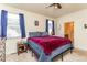 Comfortable bedroom with plush carpeting, ample natural light, and ensuite bath access at 2149 Indian Balsam Dr, Monument, CO 80132